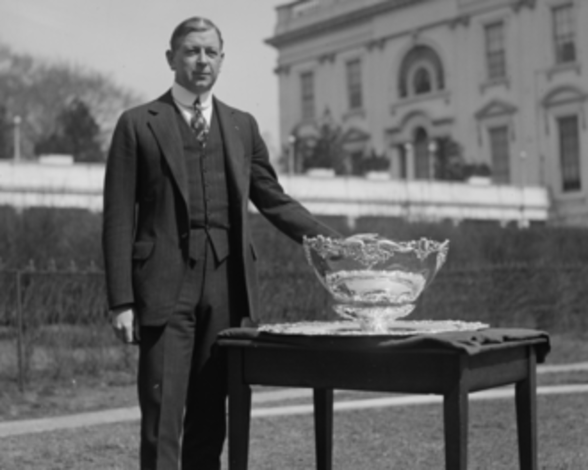 Dwight F. Davis posing with the Davis Cup.